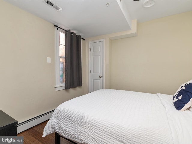 bedroom featuring a baseboard radiator and dark hardwood / wood-style flooring