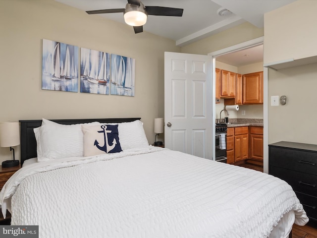 bedroom featuring ceiling fan, sink, and dark hardwood / wood-style flooring