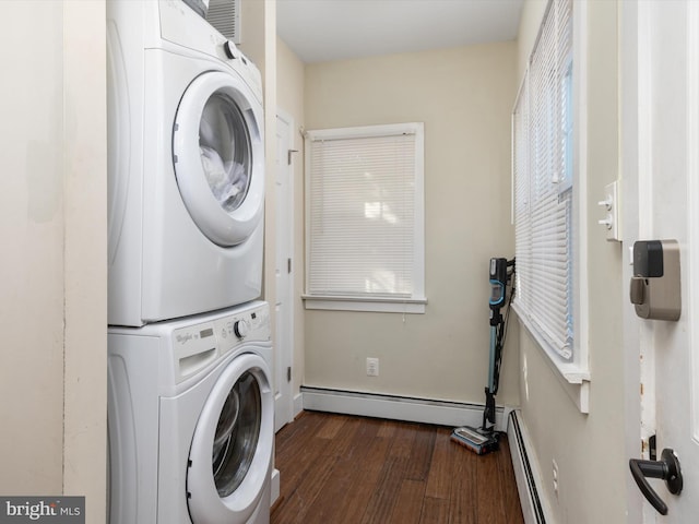 laundry room featuring dark hardwood / wood-style flooring, a baseboard radiator, and stacked washer / dryer