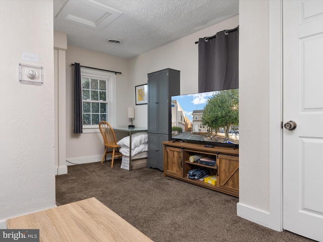 office featuring a textured ceiling and dark colored carpet