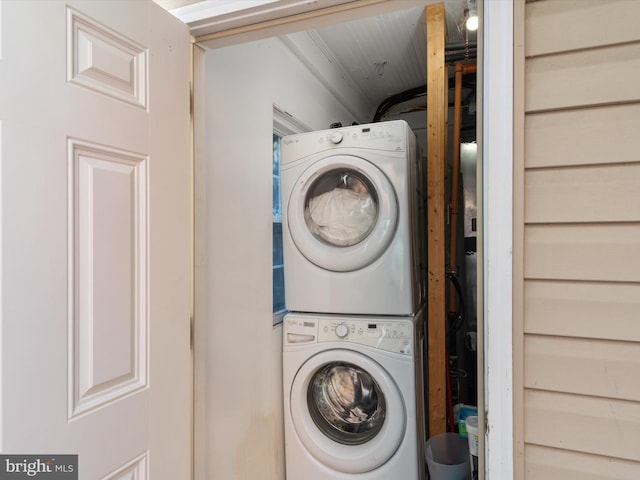 clothes washing area with stacked washer and clothes dryer