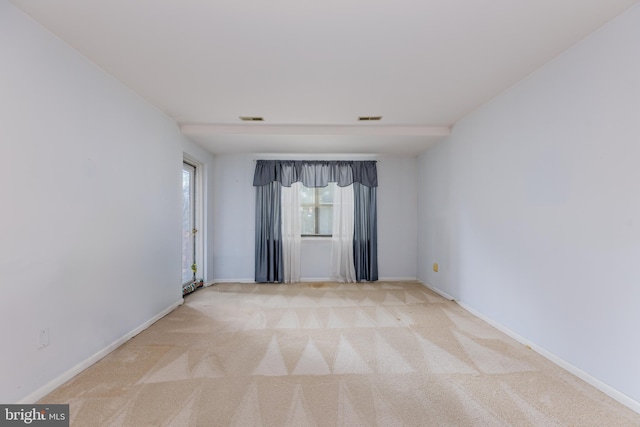 empty room with light colored carpet