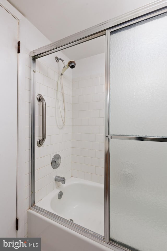 bathroom with shower / bath combination with glass door