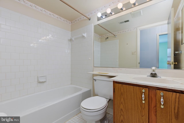 full bathroom with vanity, tiled shower / bath combo, tile patterned floors, and toilet