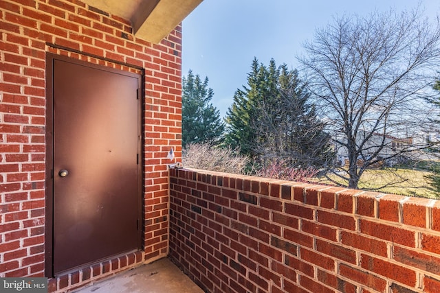 view of exterior entry featuring a balcony