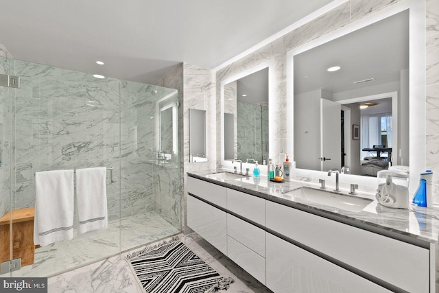 bathroom featuring vanity and a shower with door