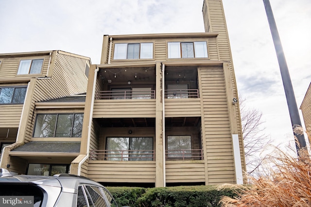 exterior space featuring a chimney and a balcony