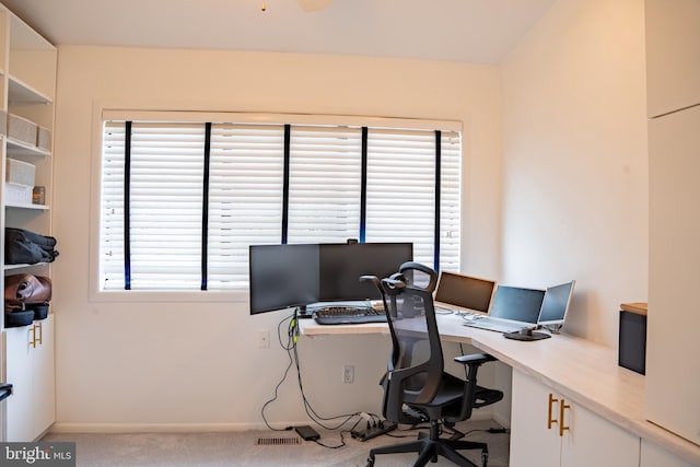 office with light carpet and baseboards