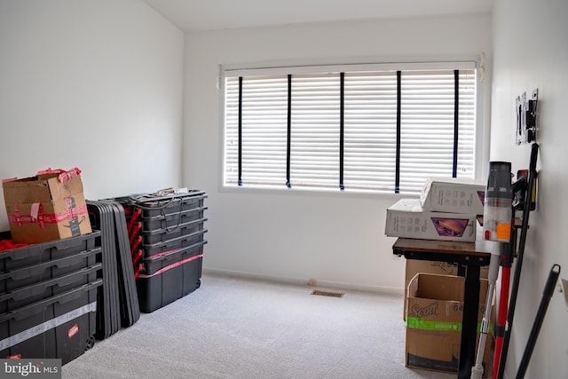 interior space featuring baseboards, visible vents, and carpet flooring