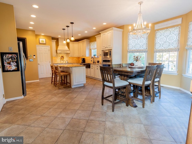 tiled dining space featuring a notable chandelier