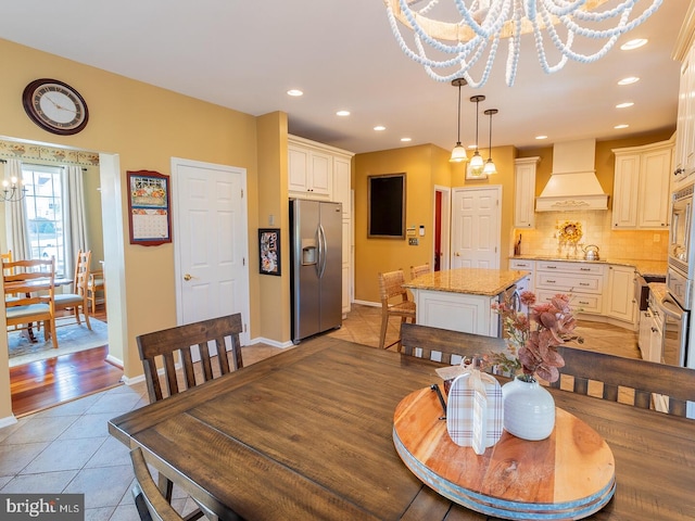 dining area with a notable chandelier and light tile patterned floors