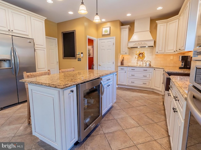 kitchen featuring stainless steel fridge, premium range hood, a center island, wine cooler, and decorative light fixtures