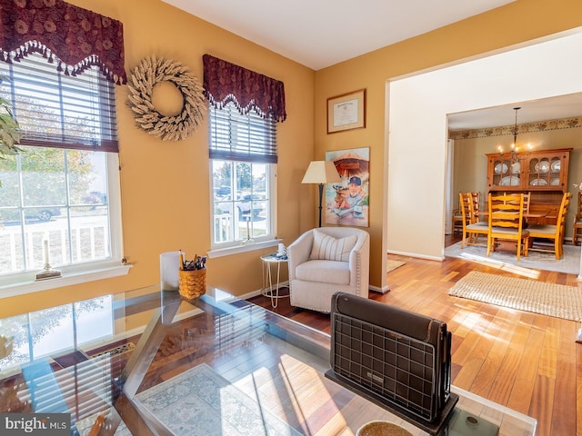 sitting room featuring hardwood / wood-style flooring and a notable chandelier