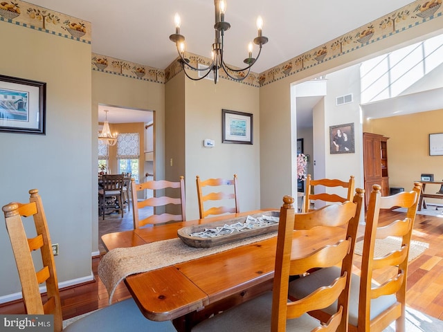 dining room featuring hardwood / wood-style floors and a chandelier