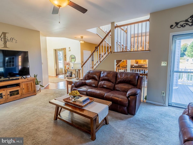 living room with vaulted ceiling, ceiling fan, and carpet flooring