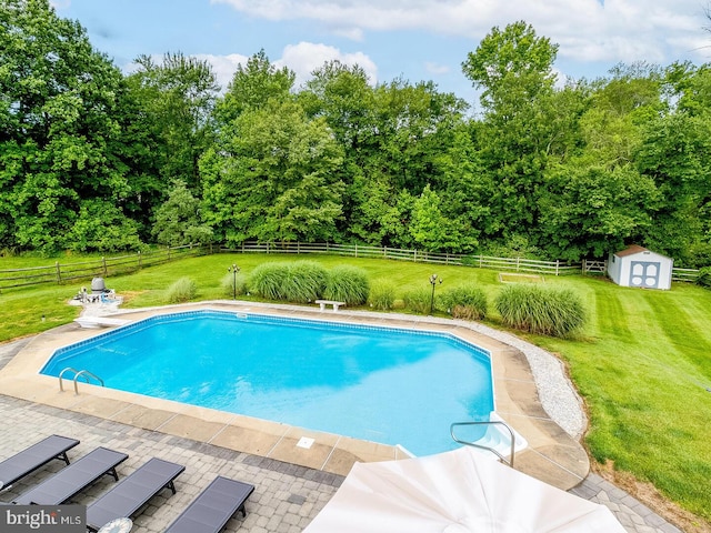 view of pool featuring a yard and a shed