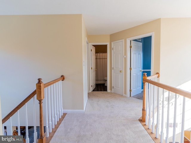 hall featuring light colored carpet