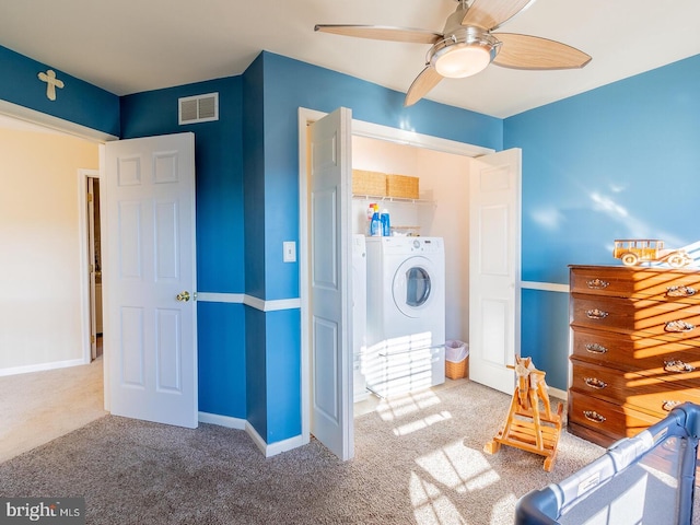 unfurnished bedroom featuring separate washer and dryer, ceiling fan, and carpet flooring