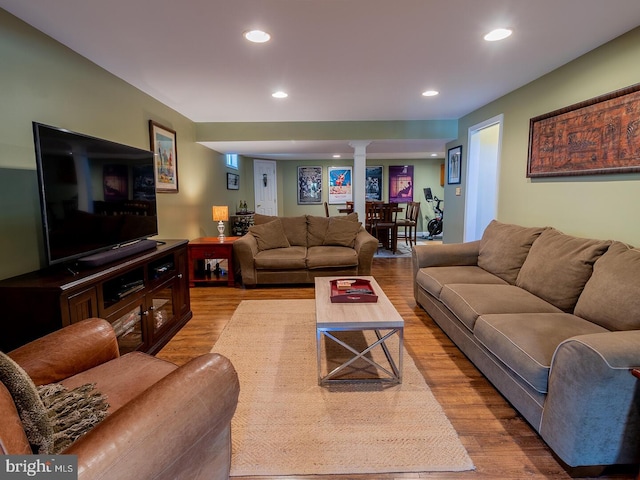 living room with hardwood / wood-style floors and decorative columns