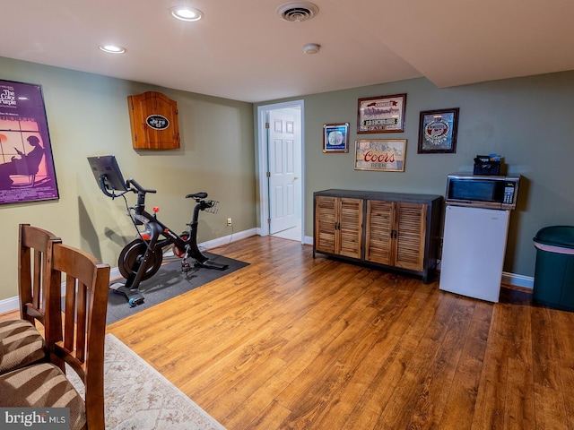 exercise area featuring dark wood-type flooring