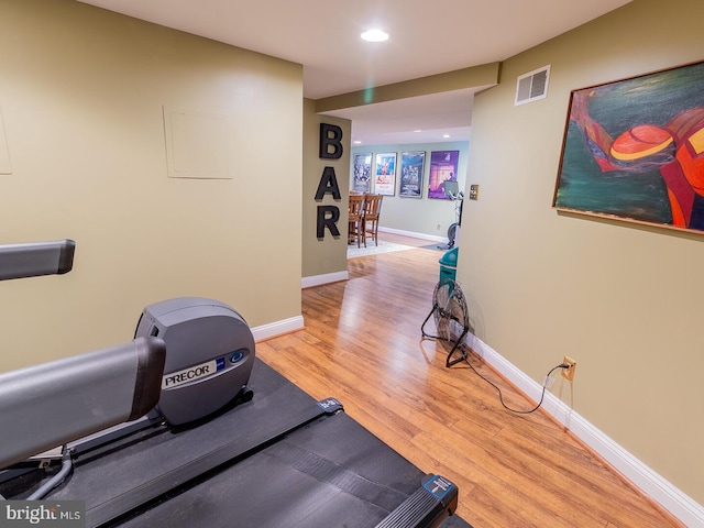 exercise area featuring light hardwood / wood-style flooring