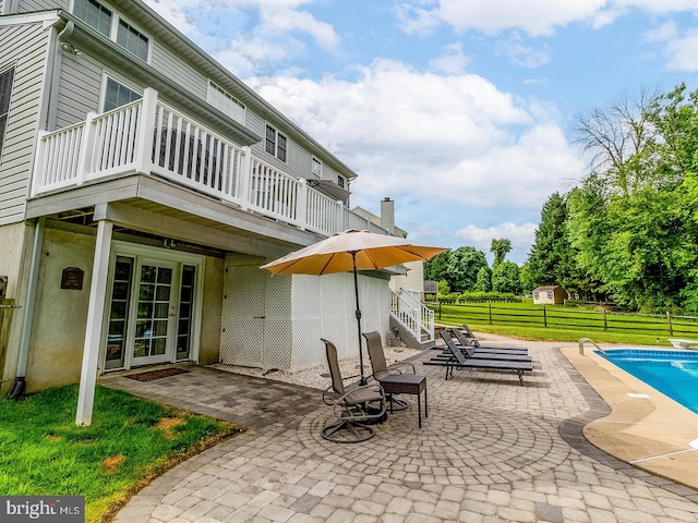 exterior space with a diving board, a lawn, and a patio