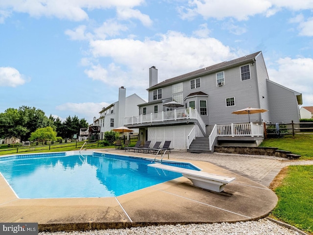 view of swimming pool with a deck and a patio area