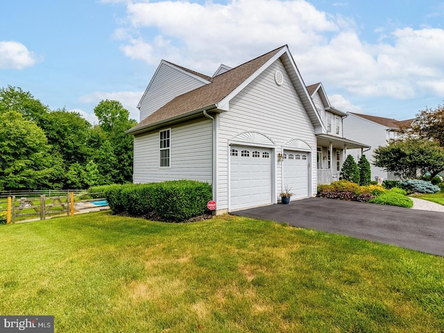 view of side of home with a garage and a lawn