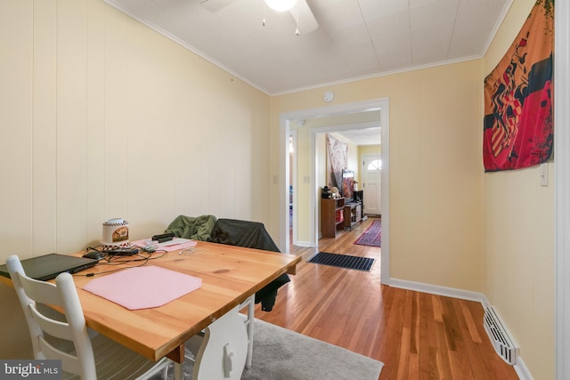 dining area featuring visible vents, ornamental molding, a ceiling fan, and light wood-style flooring