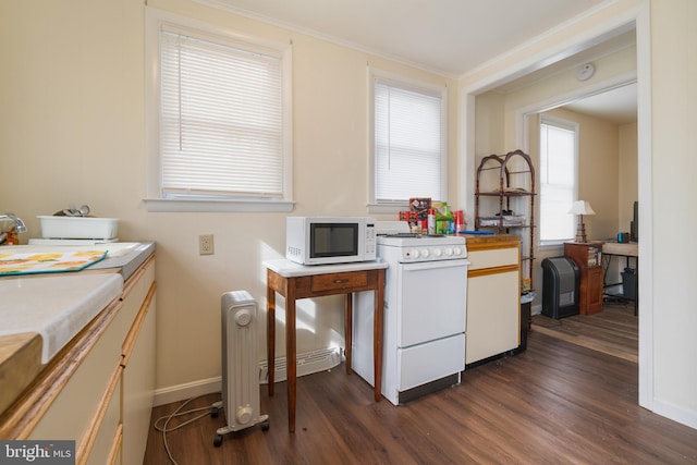 kitchen featuring radiator heating unit, white appliances, baseboards, and dark wood finished floors
