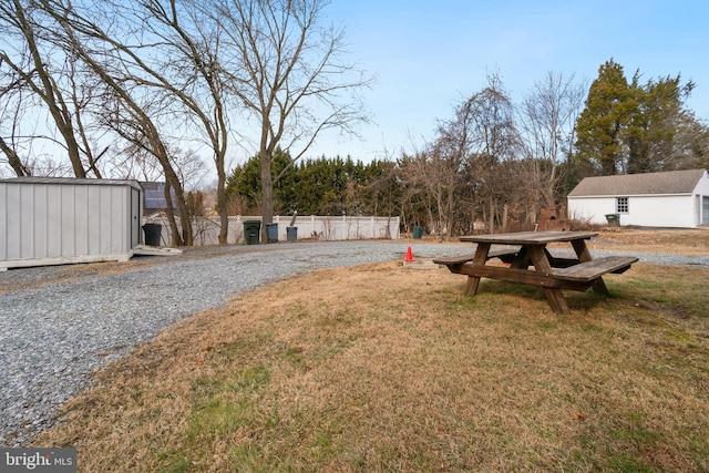 view of yard with an outbuilding and fence