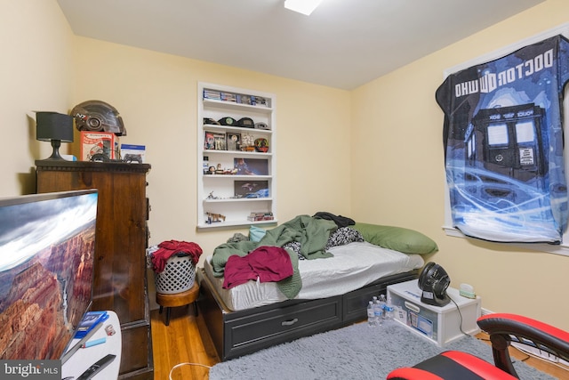 bedroom with wood finished floors