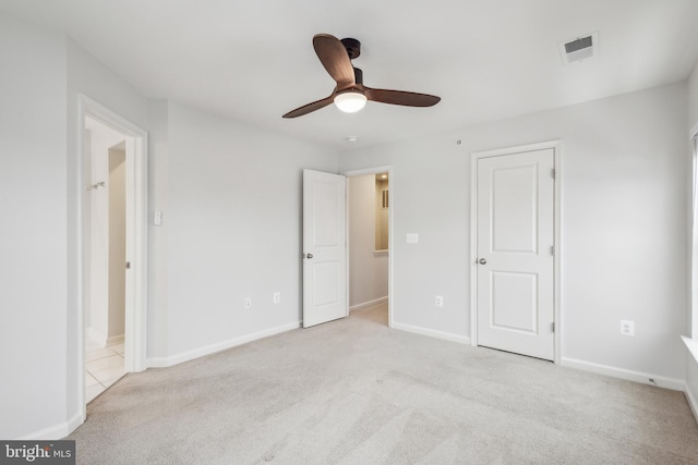 unfurnished bedroom with ceiling fan and light colored carpet