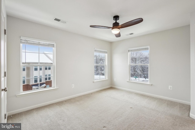 unfurnished room featuring ceiling fan and light carpet