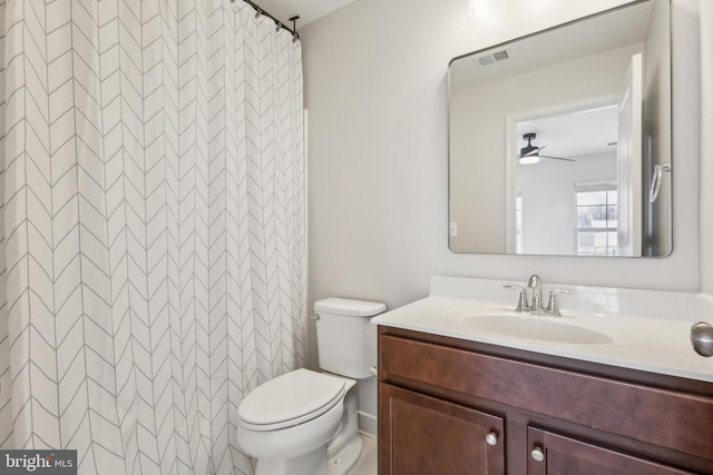 bathroom with vanity, curtained shower, and toilet