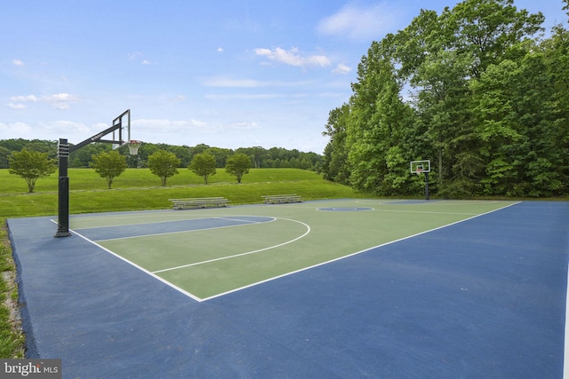 view of basketball court featuring a yard