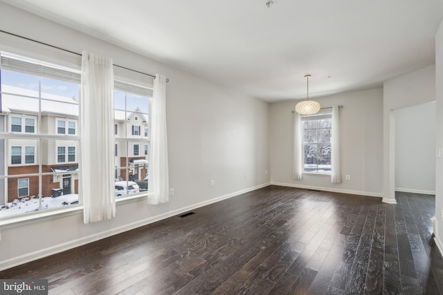 unfurnished room with dark wood-type flooring