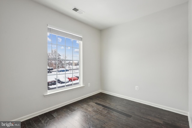 empty room with dark wood-type flooring