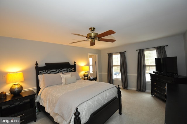 bedroom with ceiling fan and light carpet