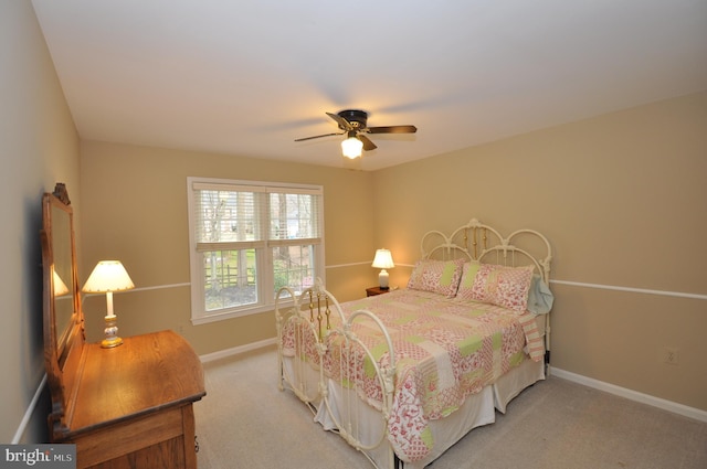 bedroom featuring light carpet and ceiling fan