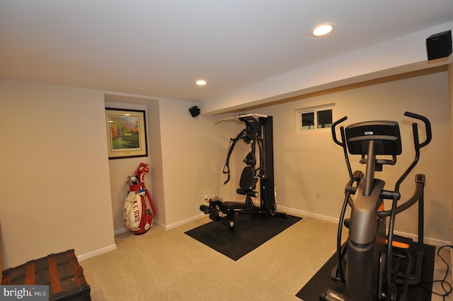 workout room featuring light carpet