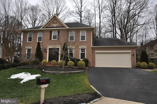 view of front of property featuring a garage and a front lawn