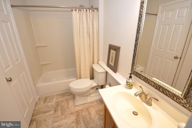 full bathroom with vanity, shower / tub combo, and toilet