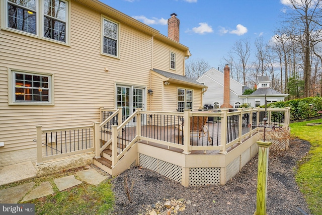 back of property with a wooden deck