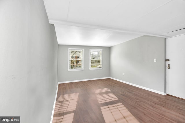 spare room featuring dark hardwood / wood-style flooring