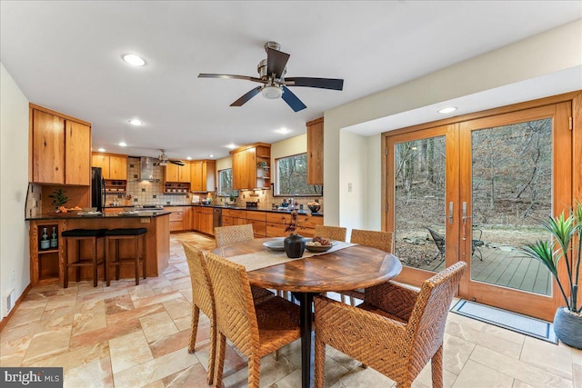 dining area with french doors, recessed lighting, visible vents, and stone tile floors