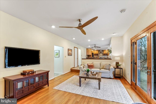 living room with baseboards, light wood finished floors, a ceiling fan, and recessed lighting