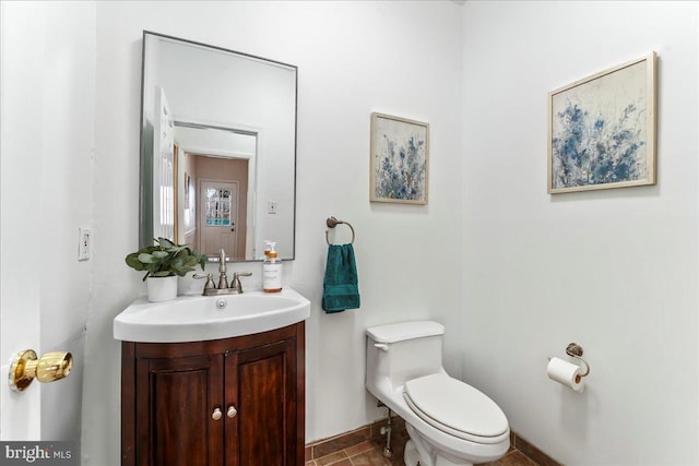 bathroom featuring toilet and vanity