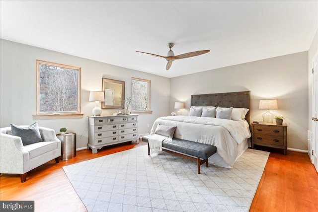 bedroom featuring light wood-type flooring, ceiling fan, and baseboards