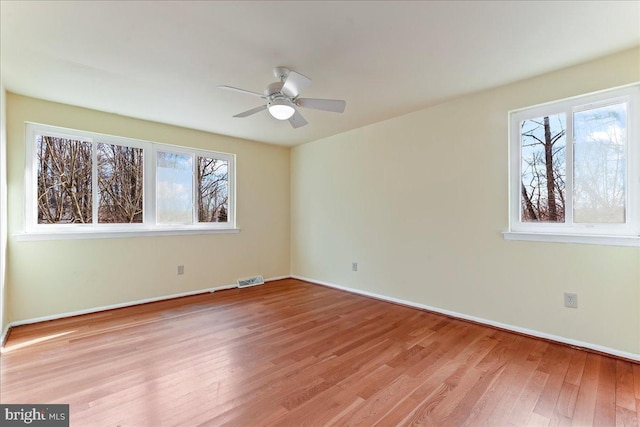 unfurnished bedroom with visible vents, baseboards, and wood finished floors